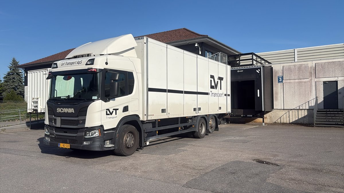 White LVT delivery truck at a loading dock